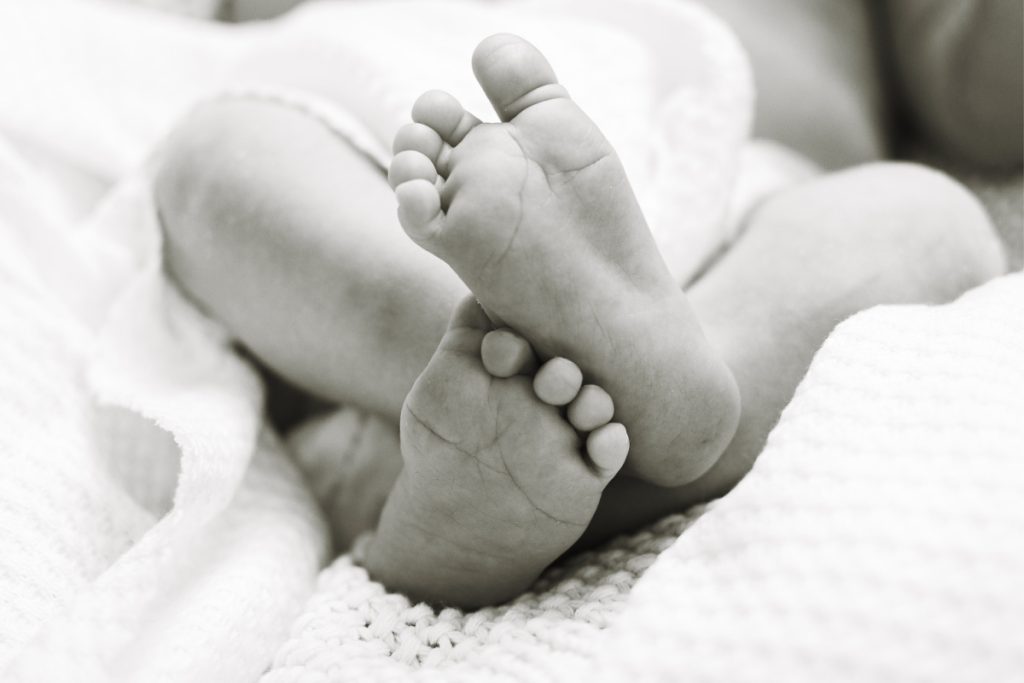 Lifestyle Newborn Photography- Dad cradling baby's head